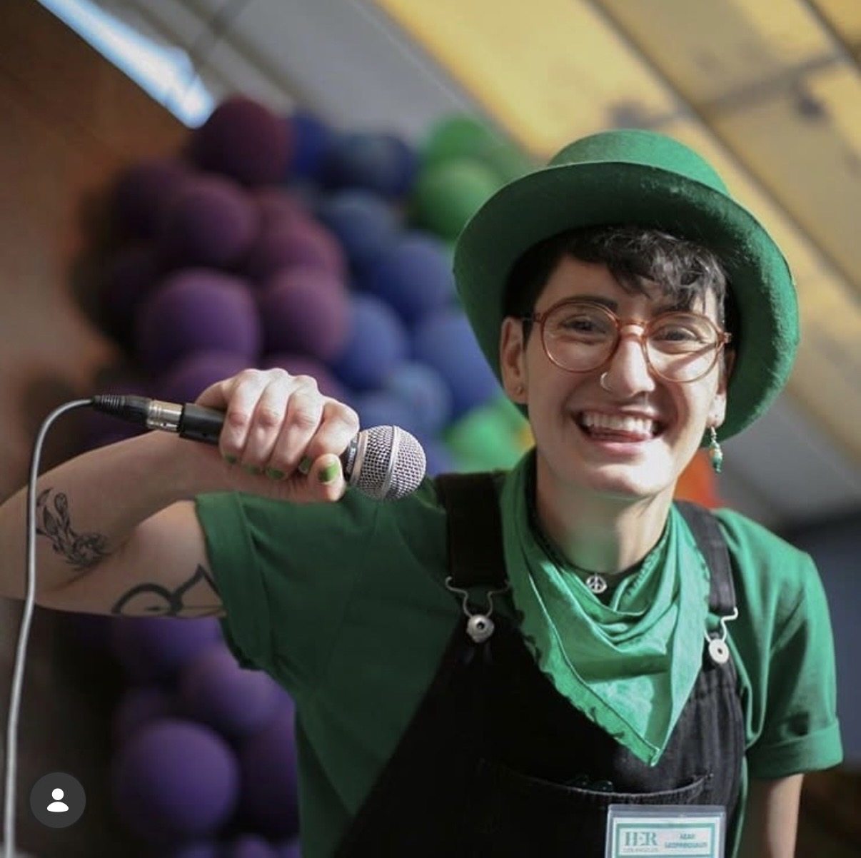 Smiling event participant holding a microphone